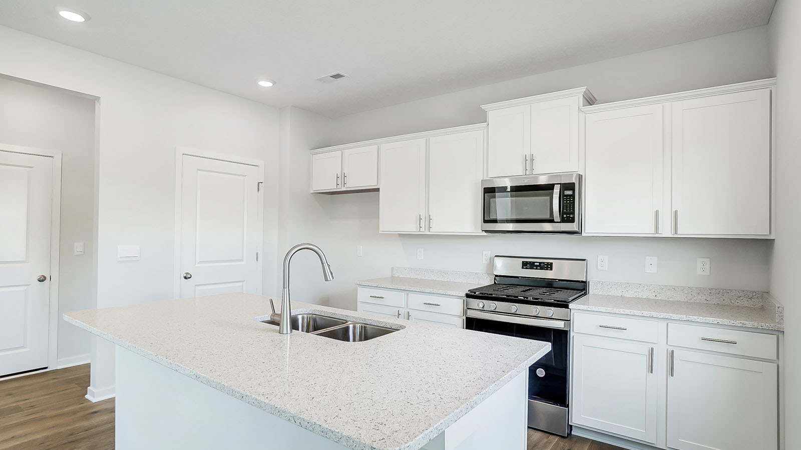 kitchen with white cabinetry, large island, and stainless steel appliances