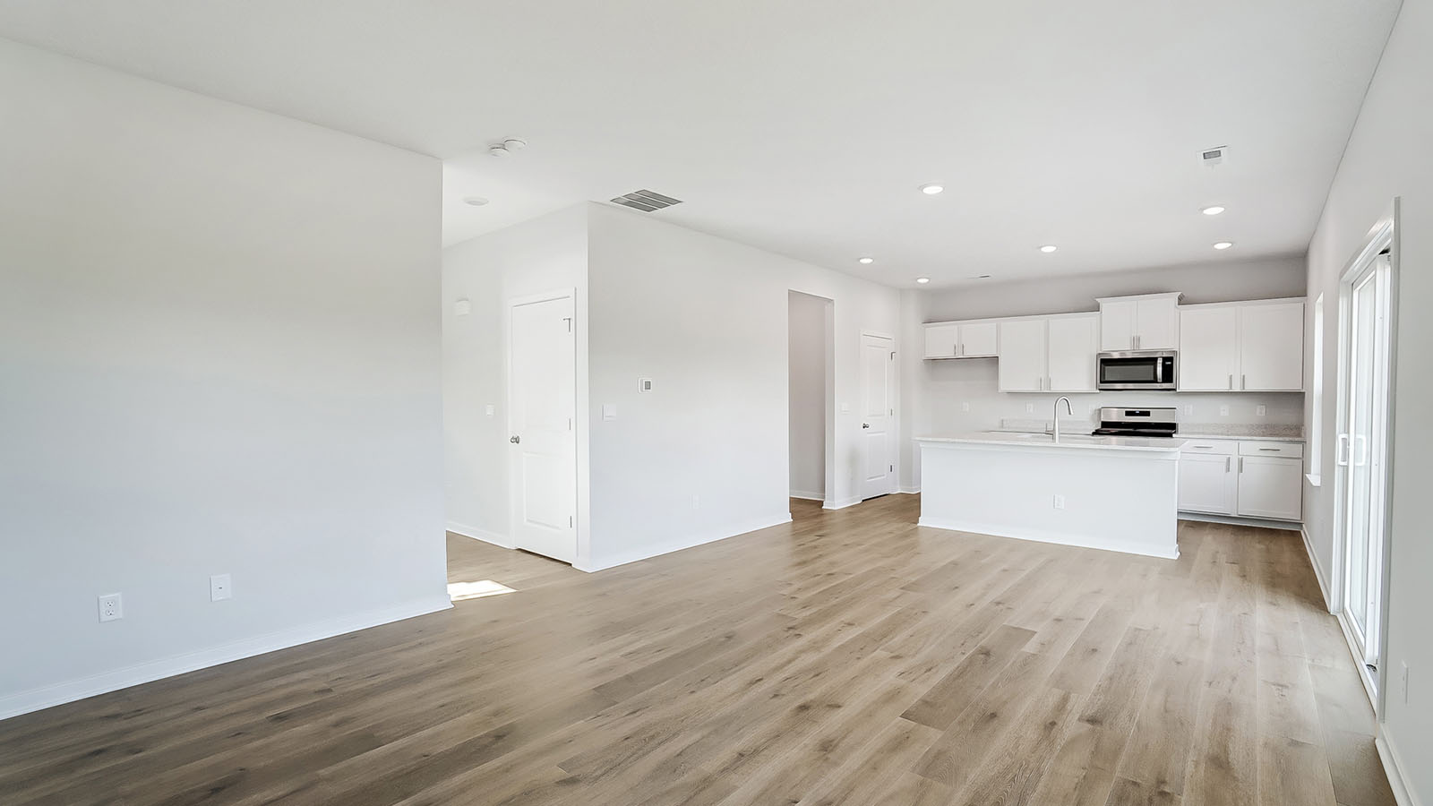 Open concept first floor with the living room, dining room and kitchen next to each other