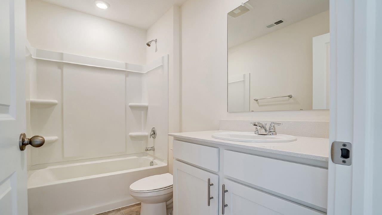 Full bathroom with tub and shower surround and transom window for light and privacy at Longview Highlands