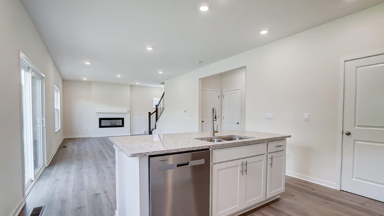 View from living room into kitchen with hard surface countertops and cabinet options at Longview Highlands