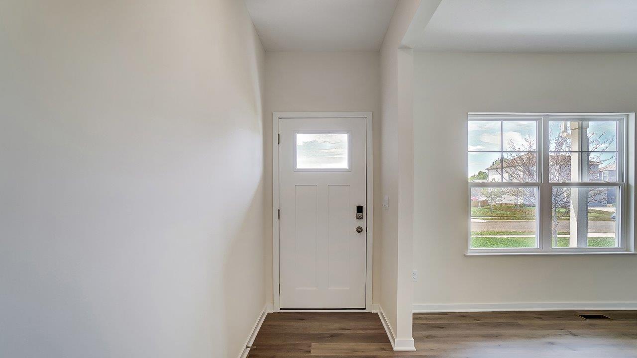 Foyer and entry hall combination layout featuring welcoming front and direct line of sight to rear windows and patio door.