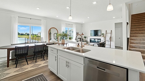 Kitchen Island View with Black barstools, white cabinets and stainless steel appliances