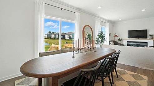 Dining Space with long, oval dark wood table and black chairs