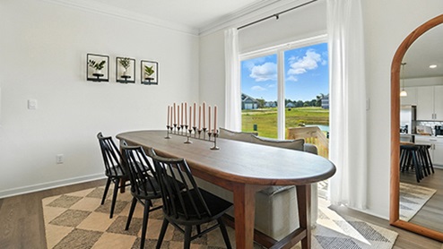 Dining Space with long, oval dark wood table and black chairs