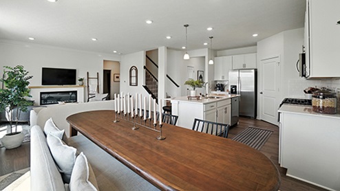 Dining Space with long, oval dark wood table and black chairs