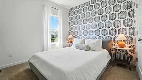 Guest bedroom with graphic wallpaper