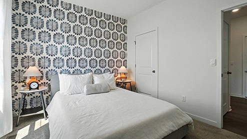 Guest bedroom with graphic wallpaper
