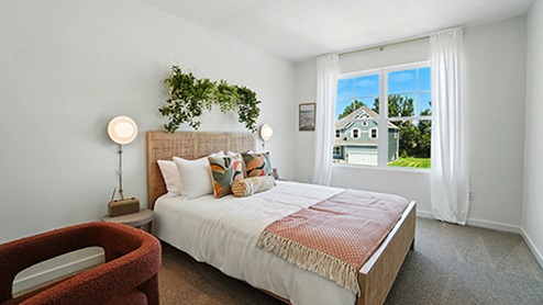 Girls bedroom with soft pink bedding and wall sconces