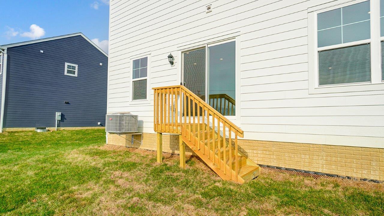 rear exterior of home featuring a spacious backyard