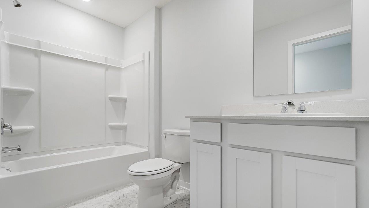 bathroom with a vanity sink, toilet, and a walk in shower