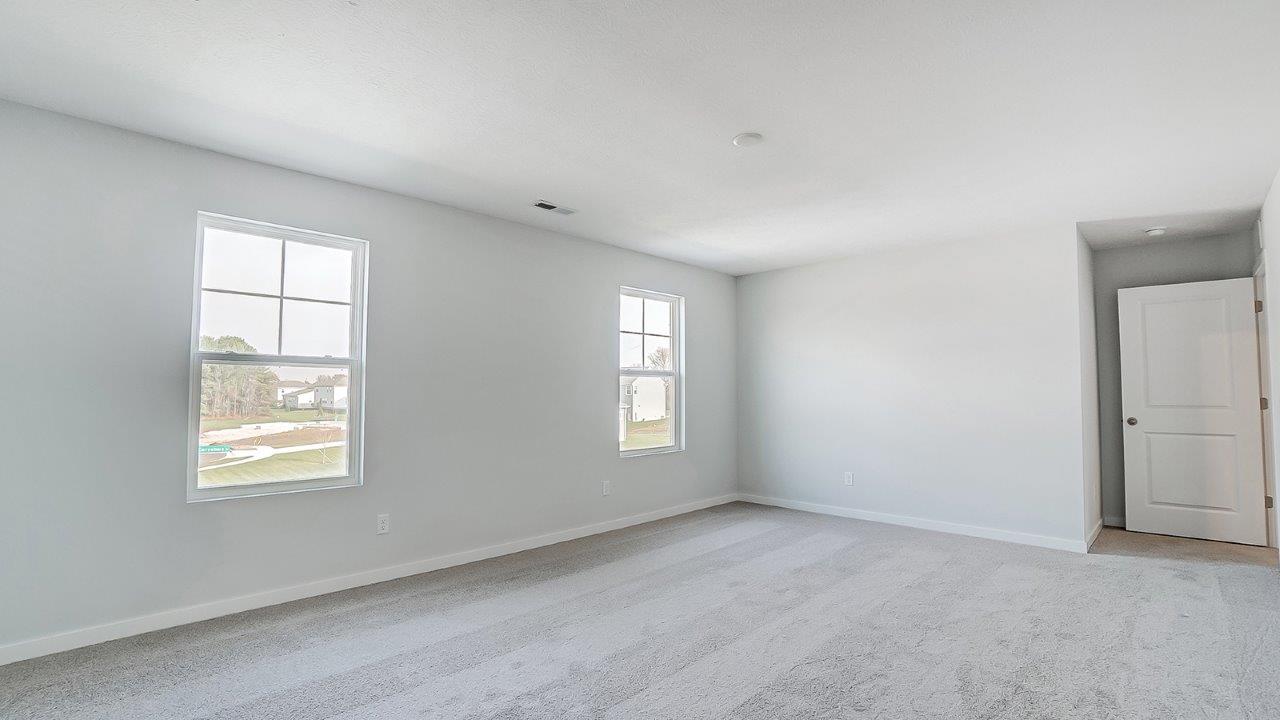 bedroom with grey carpet, grey walls and a window