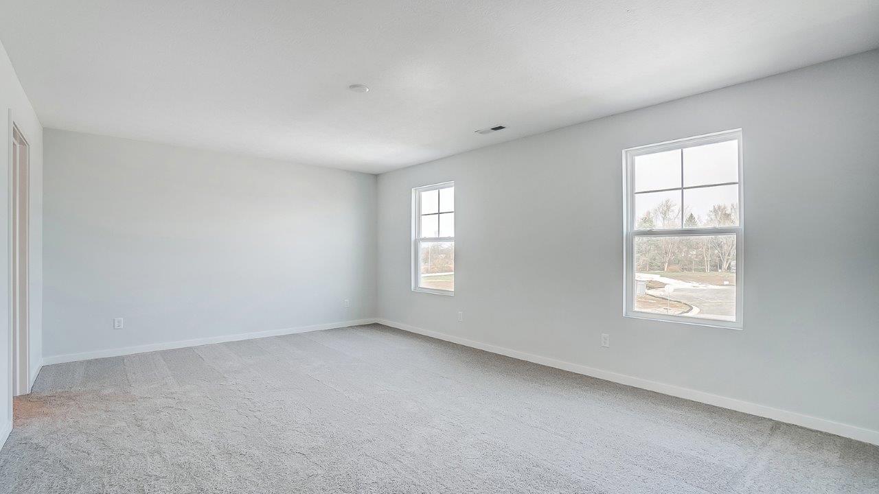 bedroom with grey carpet, grey walls and a window