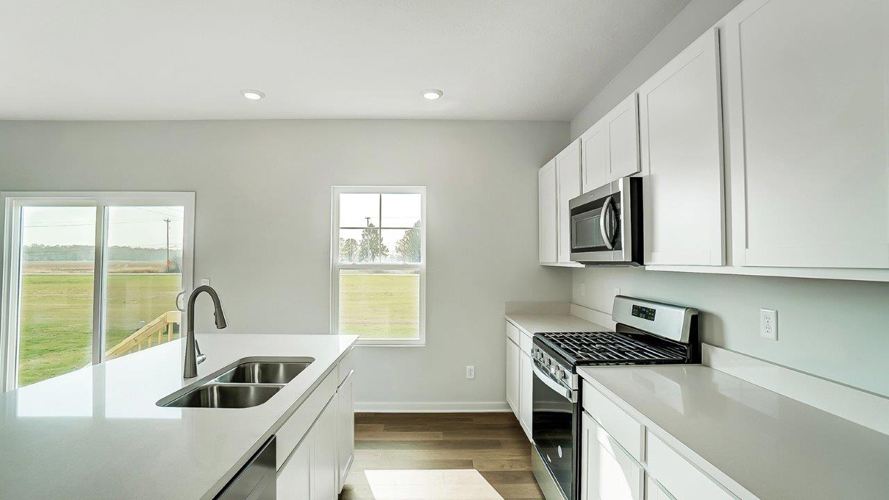 kitchen with white cabinetry, large island, and stainless steel appliances