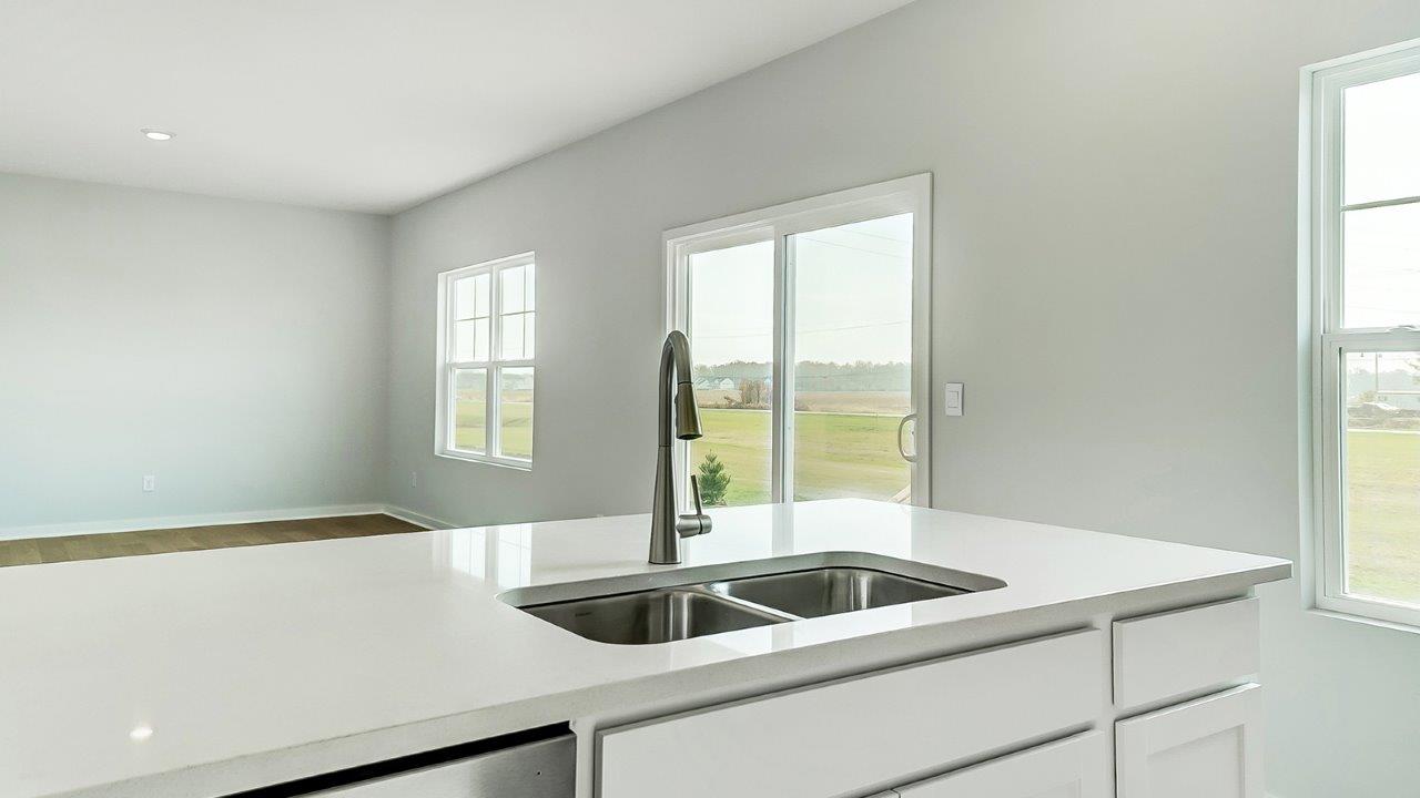 kitchen with white cabinetry, large island, and stainless steel appliances