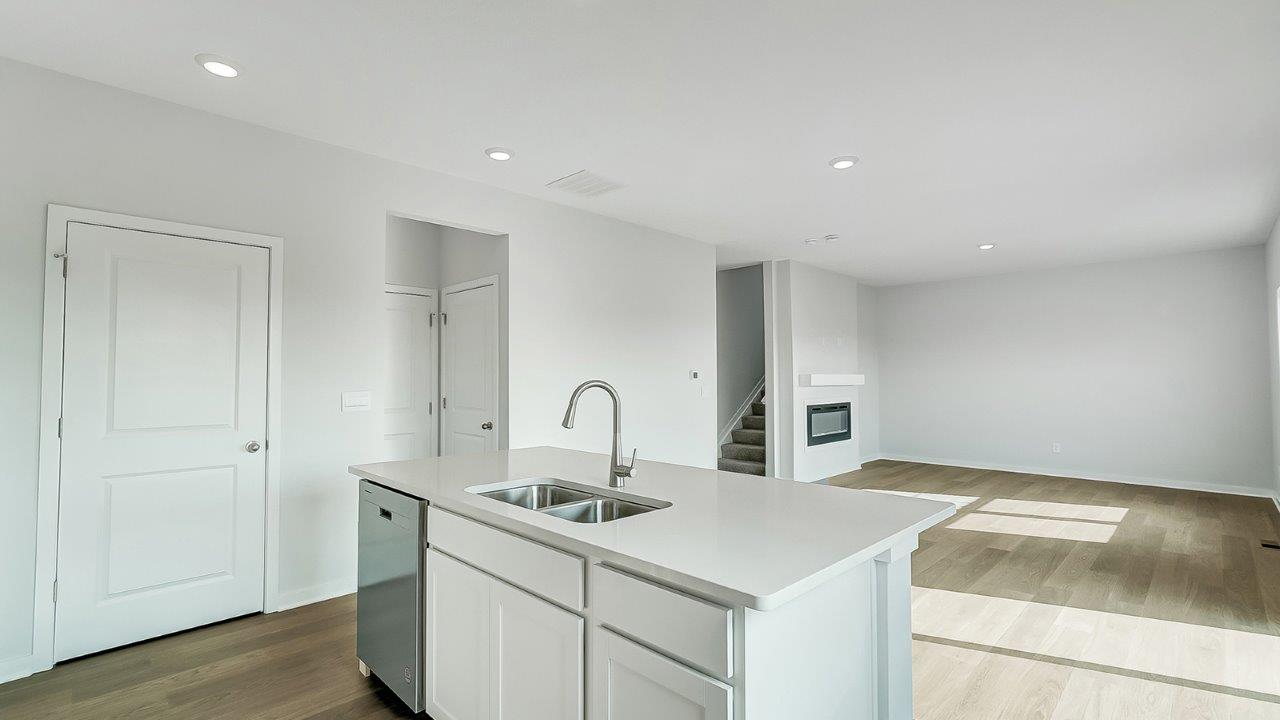 kitchen with white cabinetry, large island, and stainless steel appliances