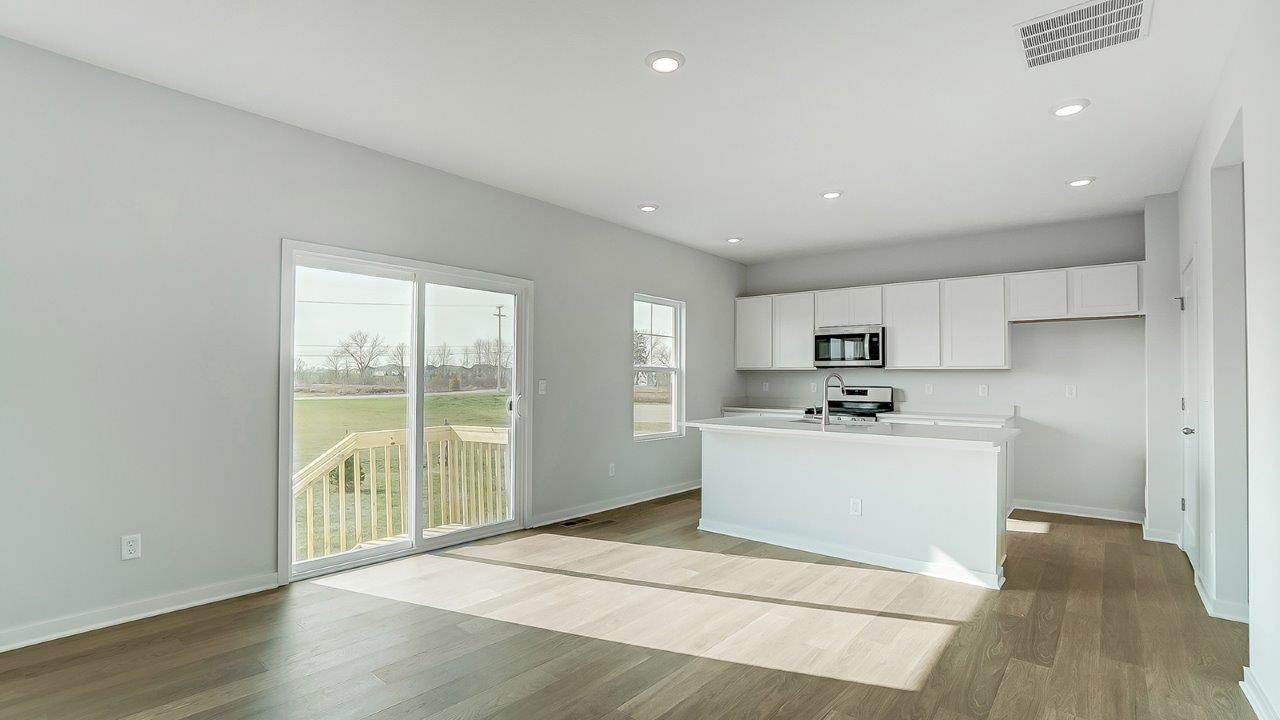 kitchen with white cabinetry, large island, and stainless steel appliances