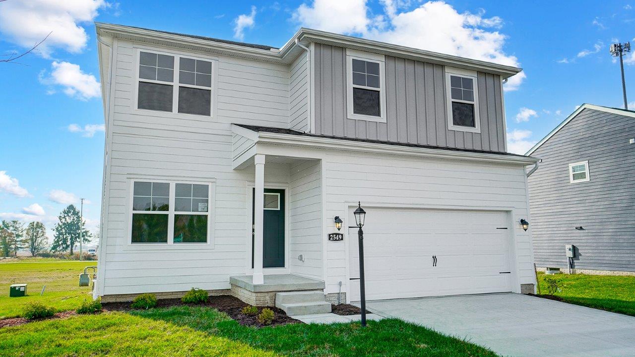 front exterior of a two story home with a two car garage