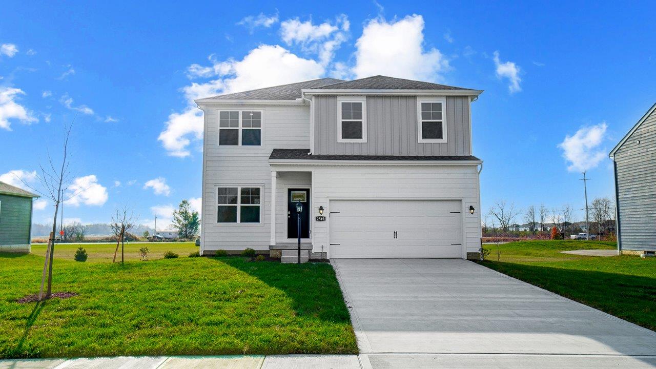 front exterior of a two story home with a two car garage