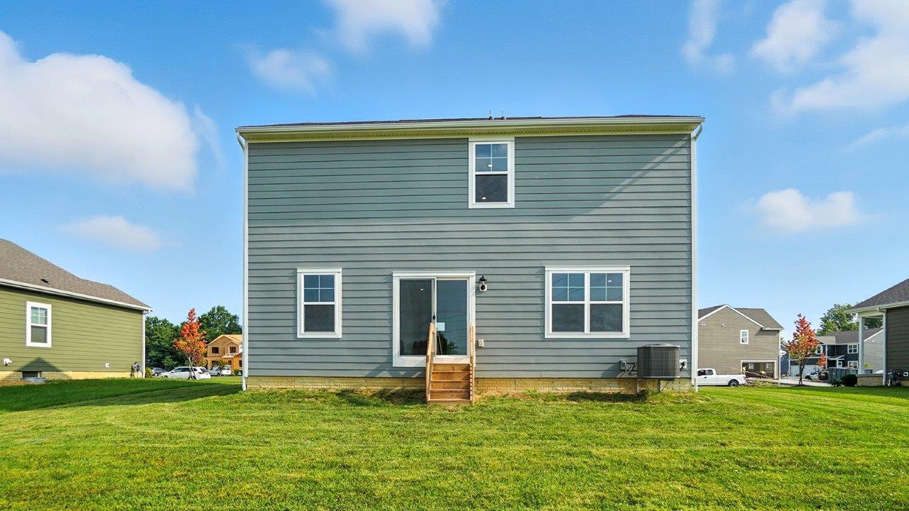 two story home with grey siding rear exterior