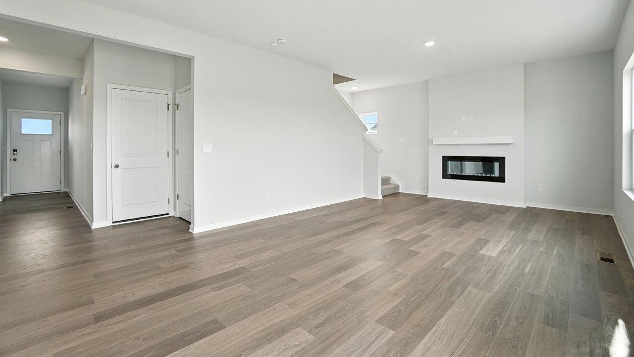foyer and great room with electric fireplace