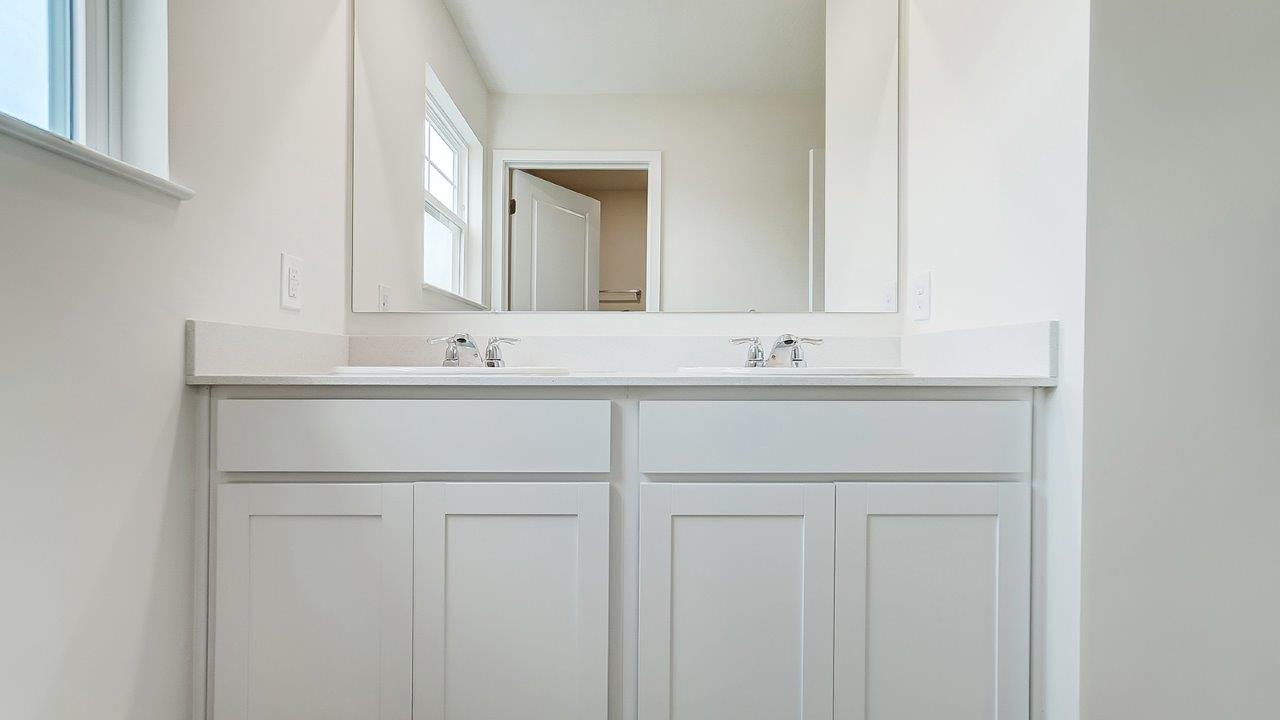 bathroom with dual vanity sinks