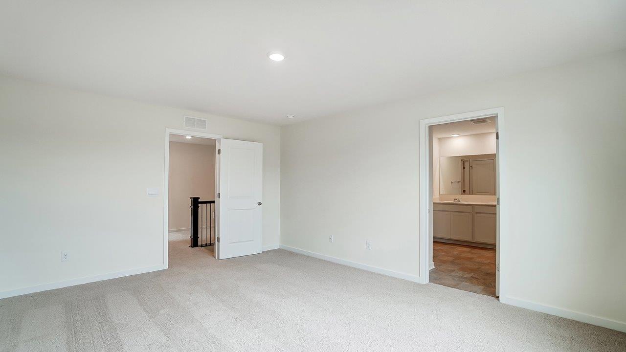 View of the bedroom overlooking the closet and hallway doors