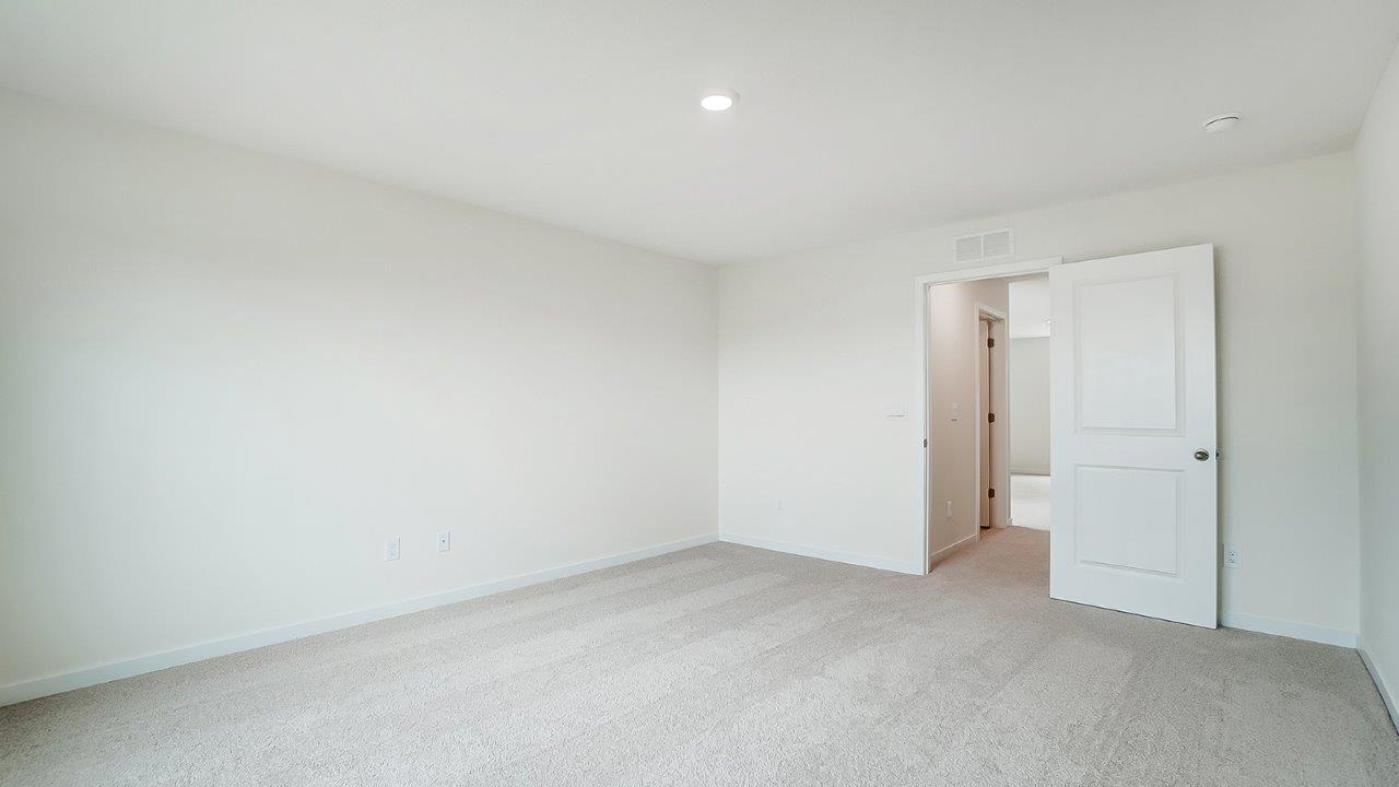 View of the bedroom overlooking the closet and hallway doors