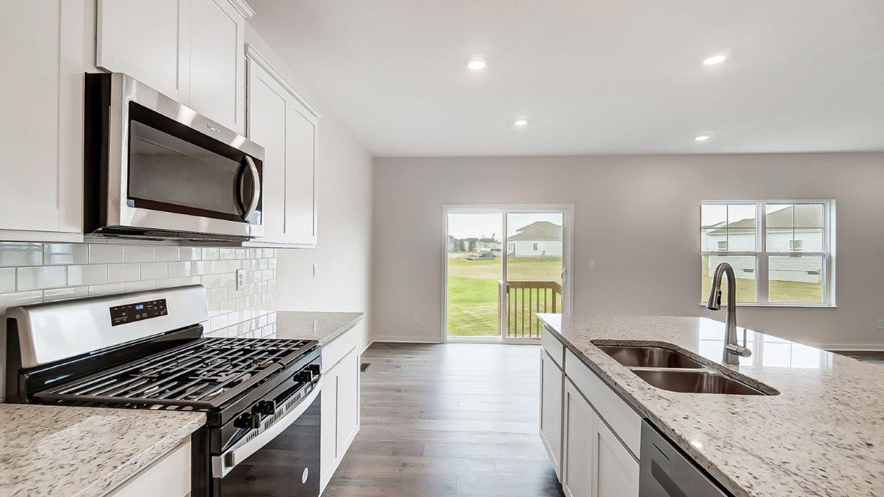 kitchen with white cabinetry, large island and stainless steel appliances