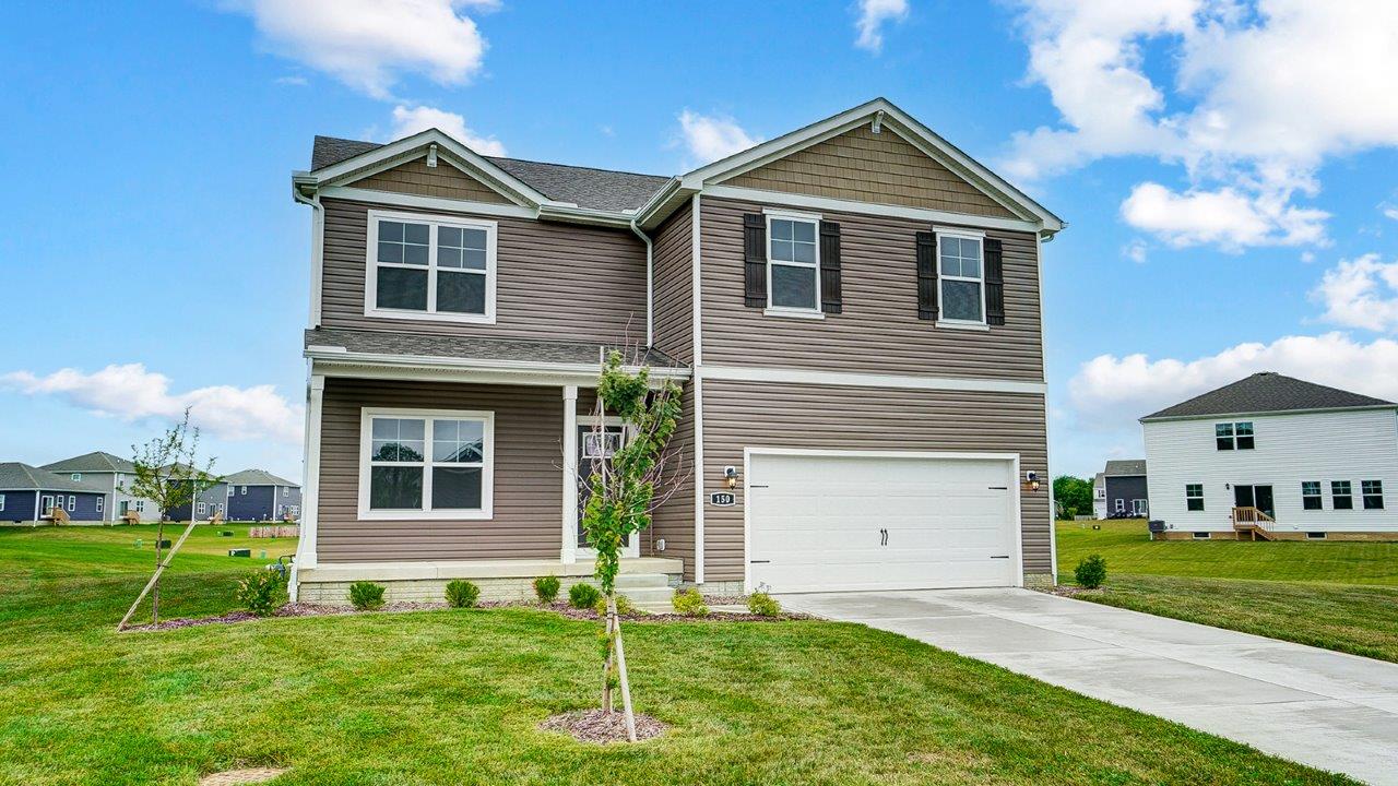 Front exterior of a two story home with grey siding and a 2 car garage