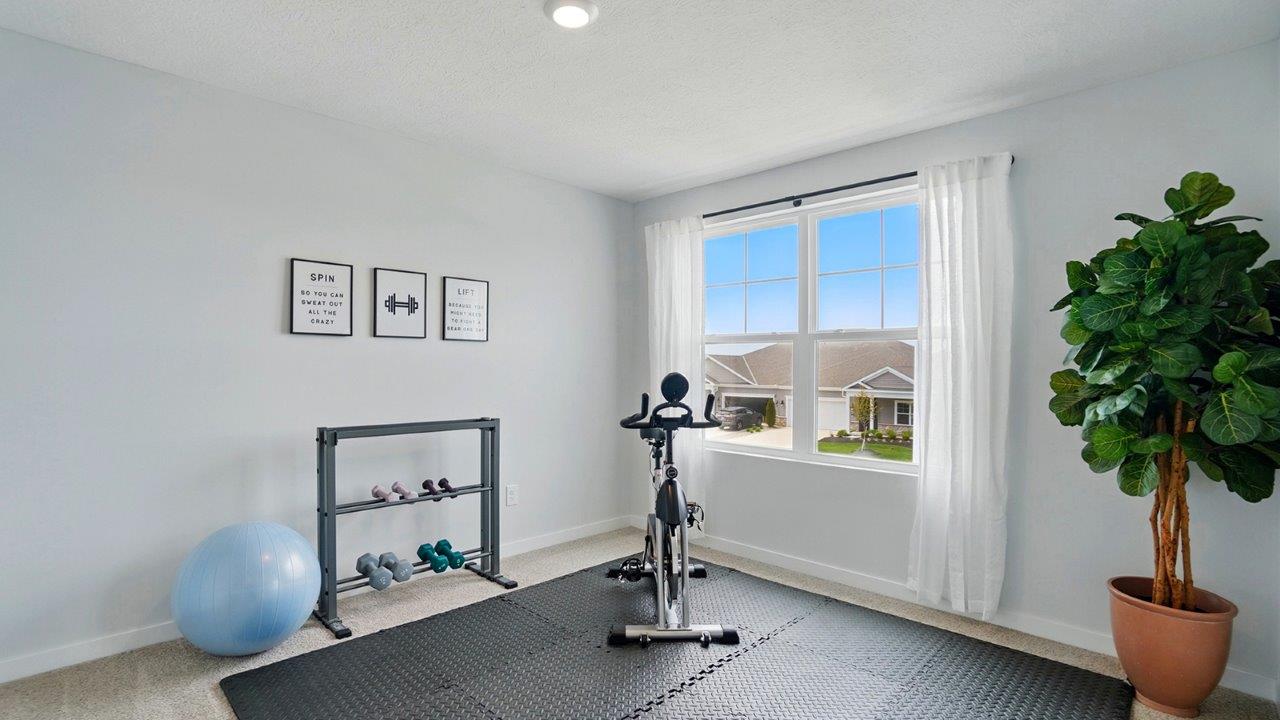 home gym with a large window, and workout equipment