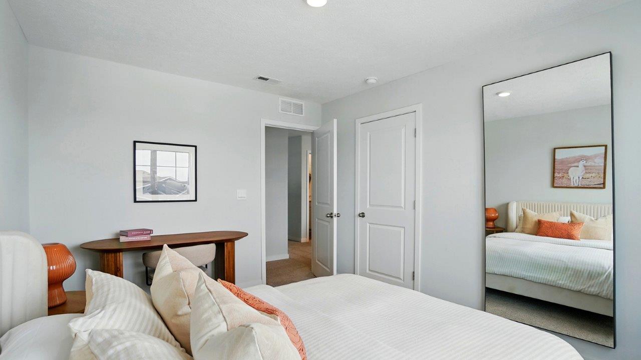 bedroom with a white bed, large window and brown night stand