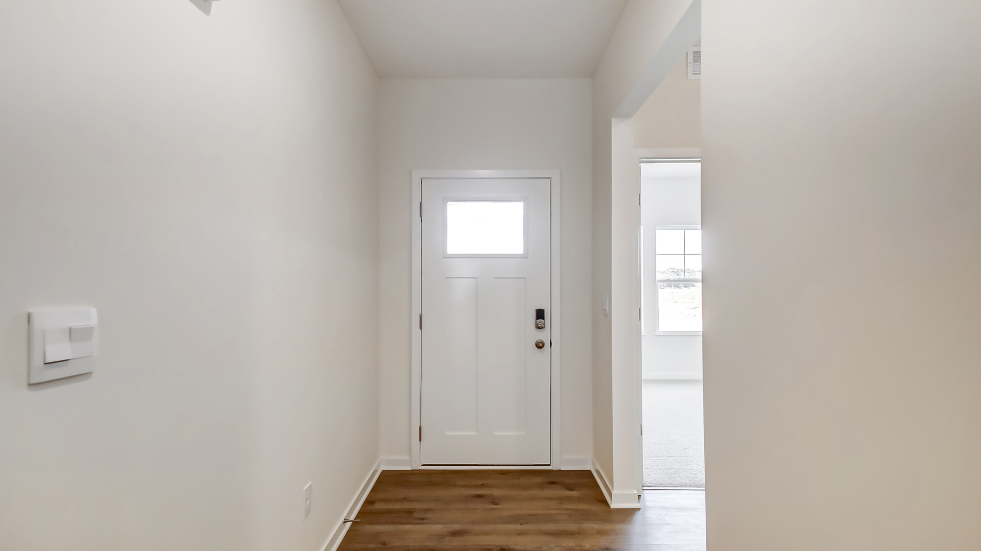 Entryway with bright hallway.