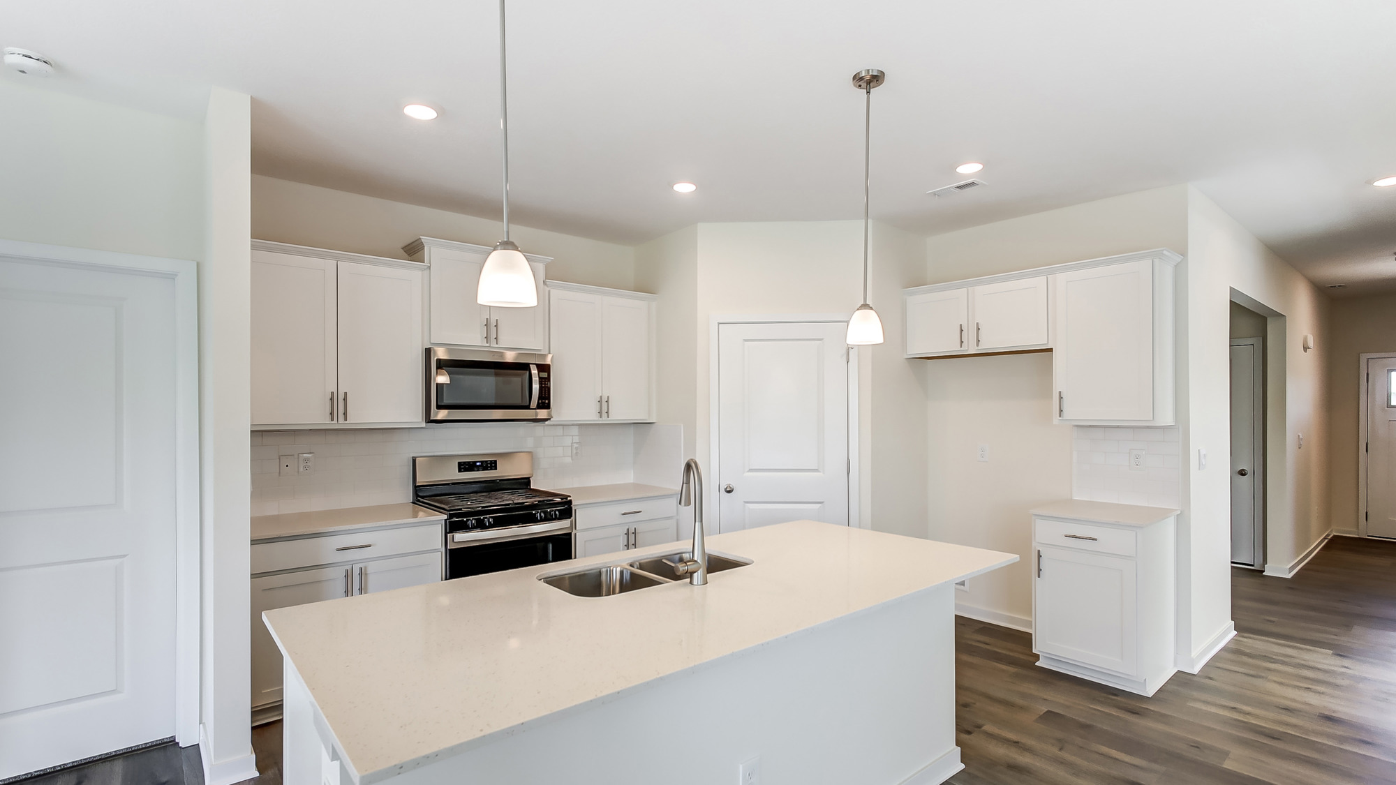 Kitchen featuring cabinets, new stainless steel appliances, and a large standing island.