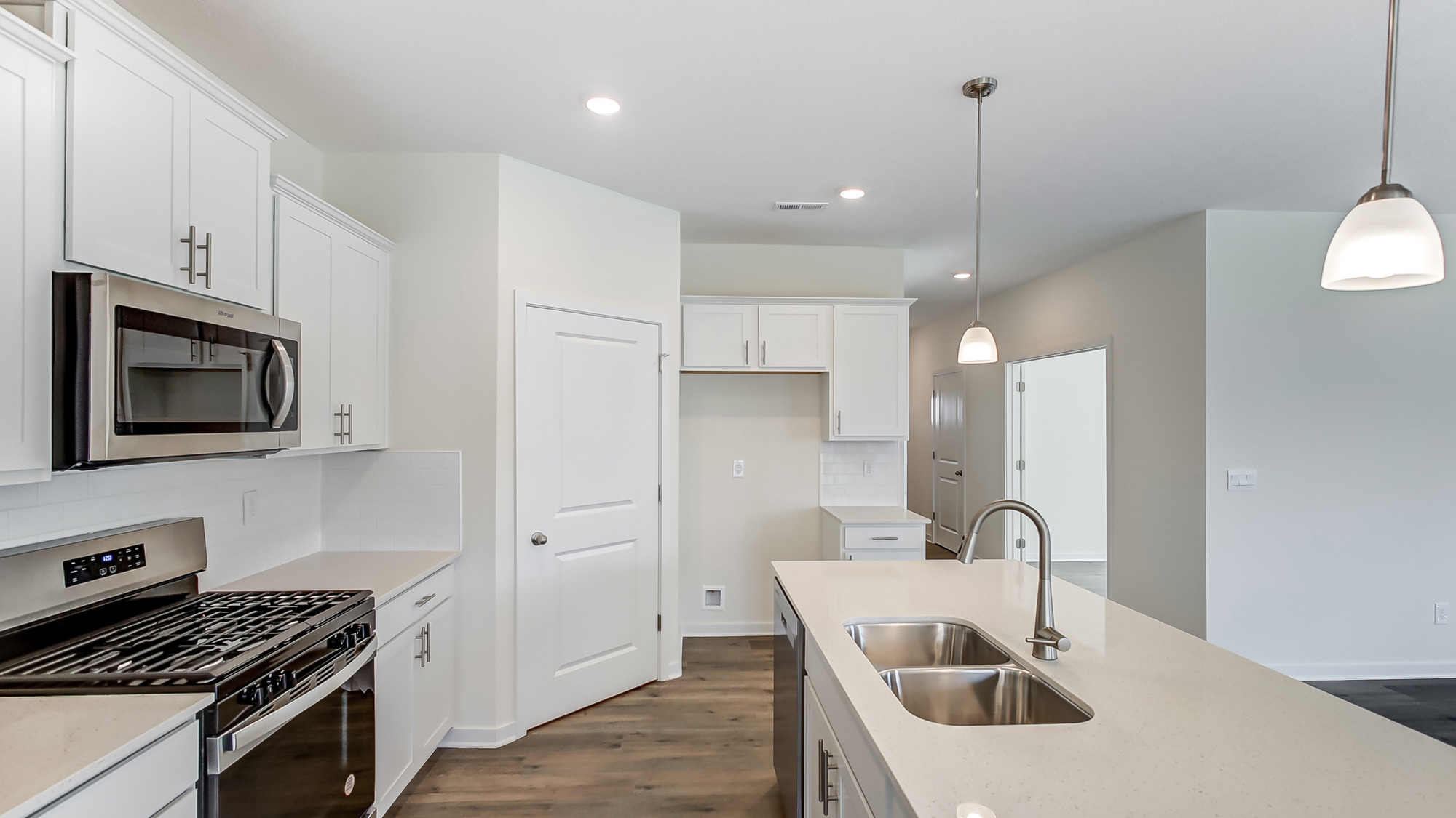 Kitchen featuring cabinets, new stainless steel appliances, and a large standing island.