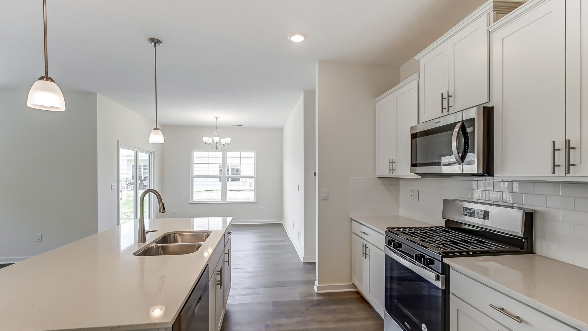 Open kichen connected to dining space with natural light.