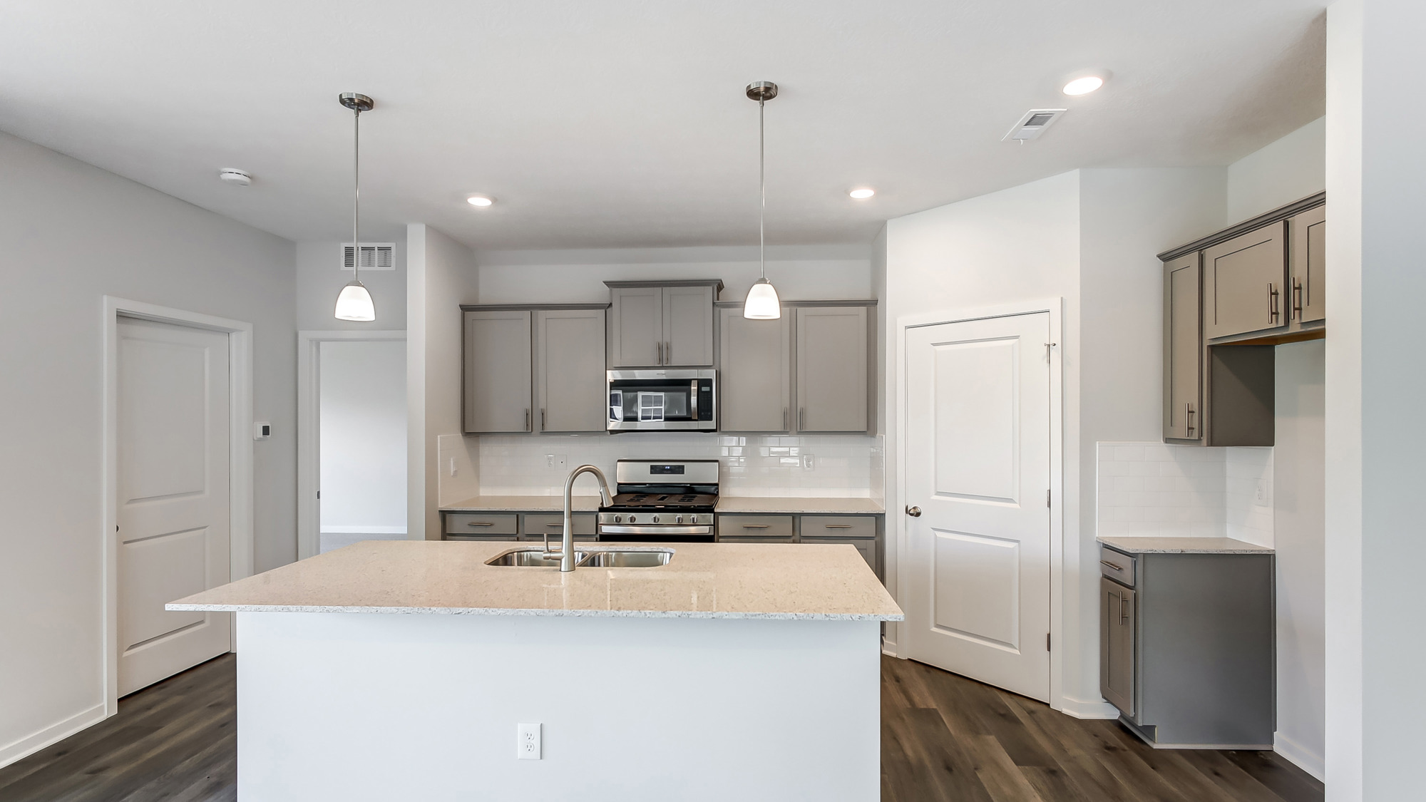 Kitchen featuring brand new stainless steel appliances, cabinets, and a large island.