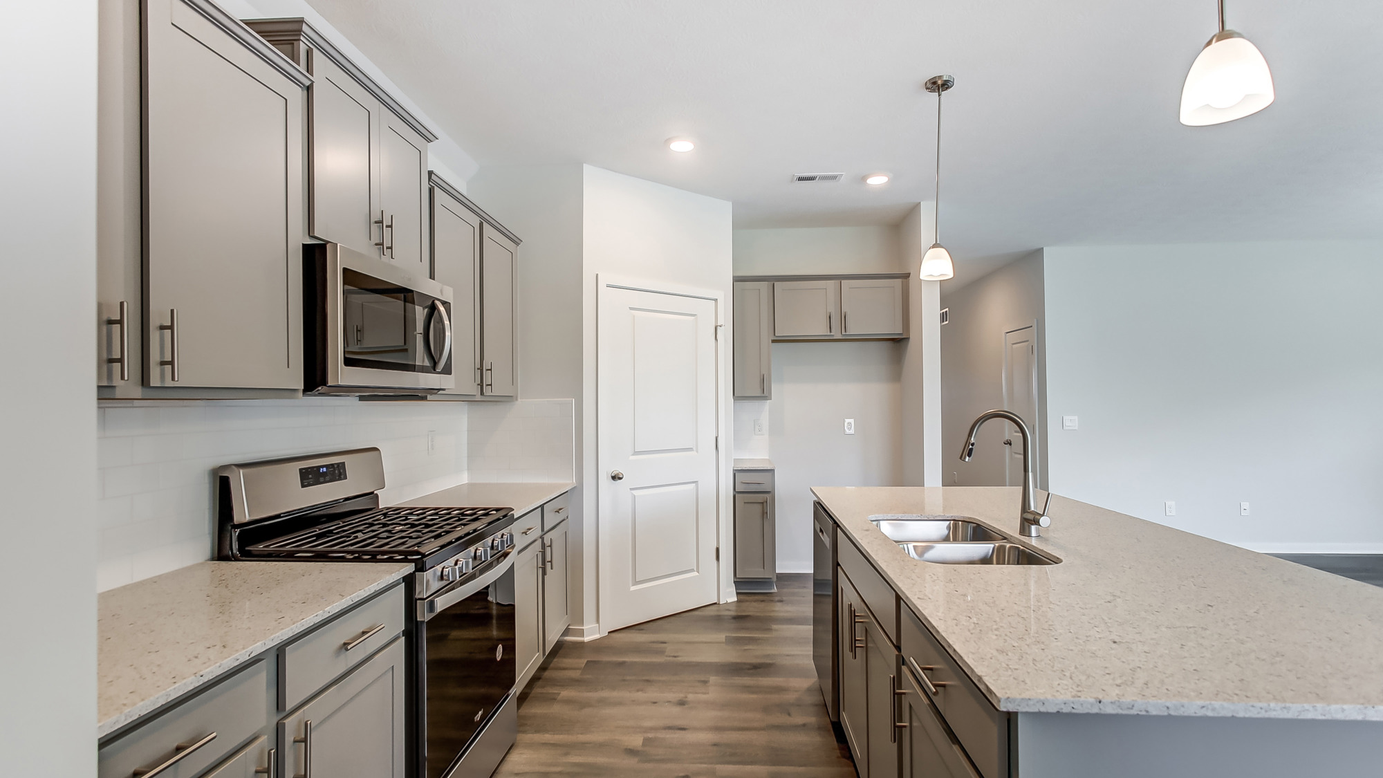 Kitchen with new hard surface countertops and new stainless steel appliances.