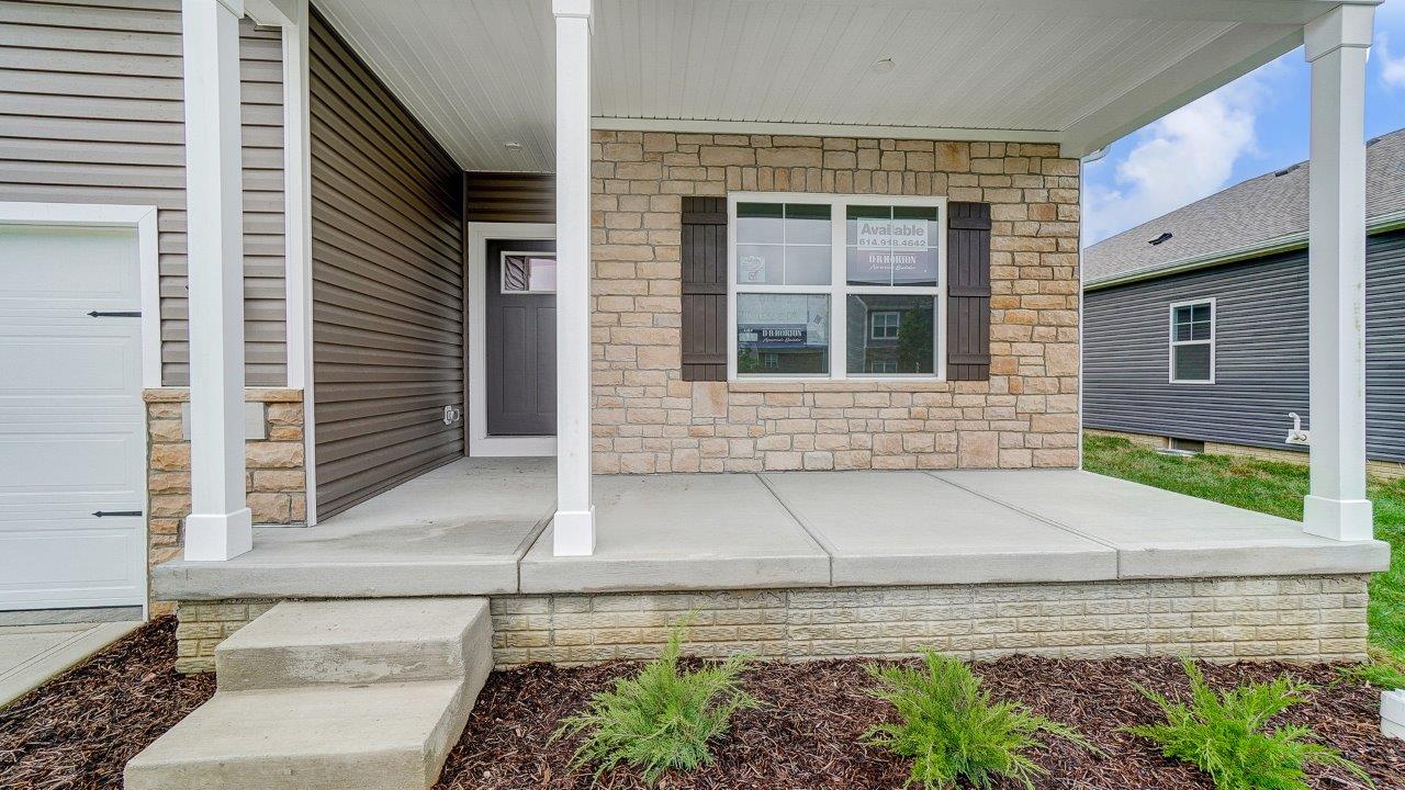 Close up of covered front porch with stone detailing.