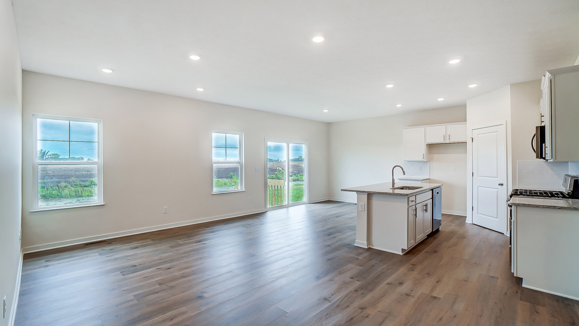 Spacious kitchen with brand new stainless steel appliances connecting to the living area.