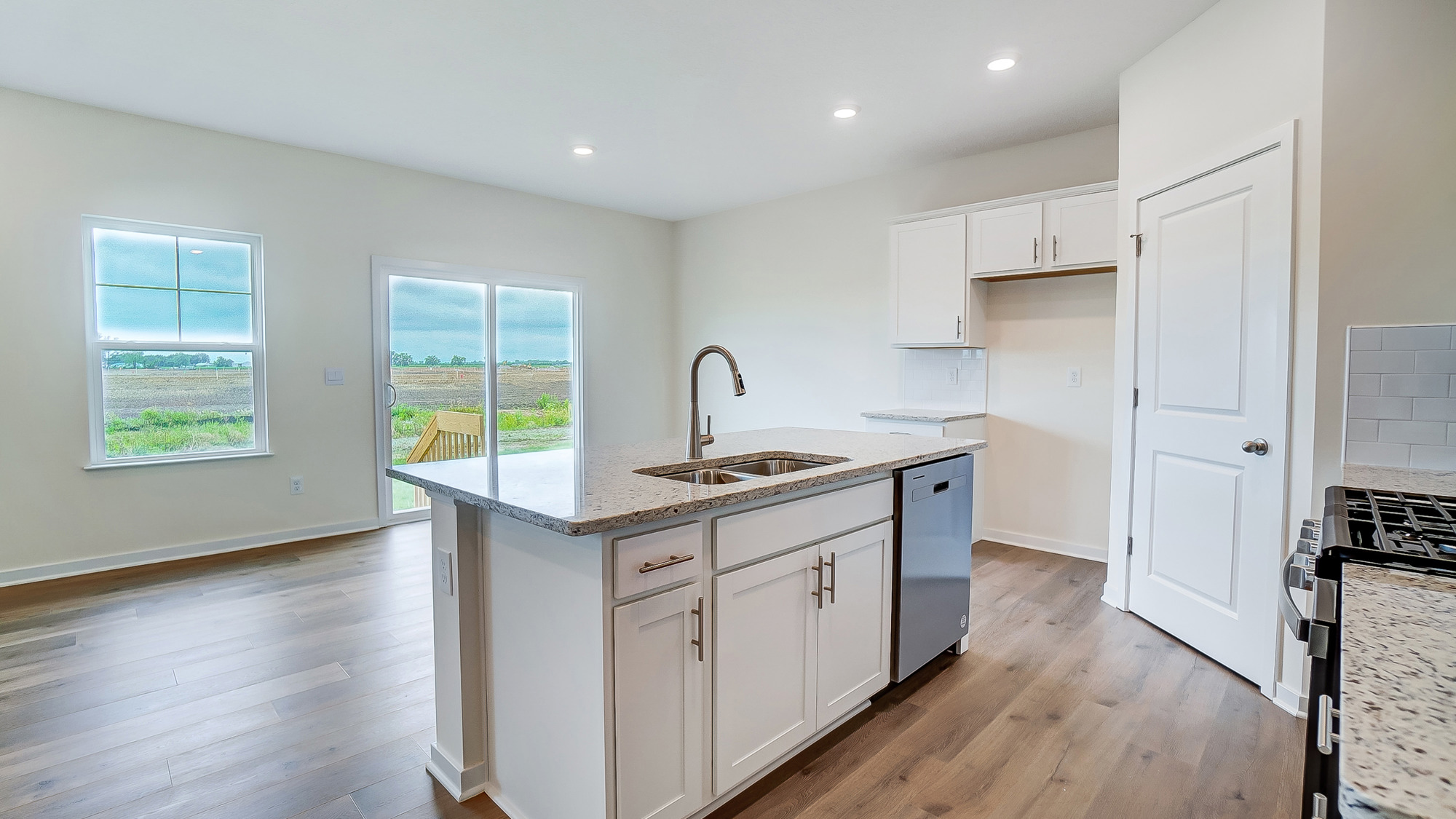 Open kichen connected to dining space with natural light.