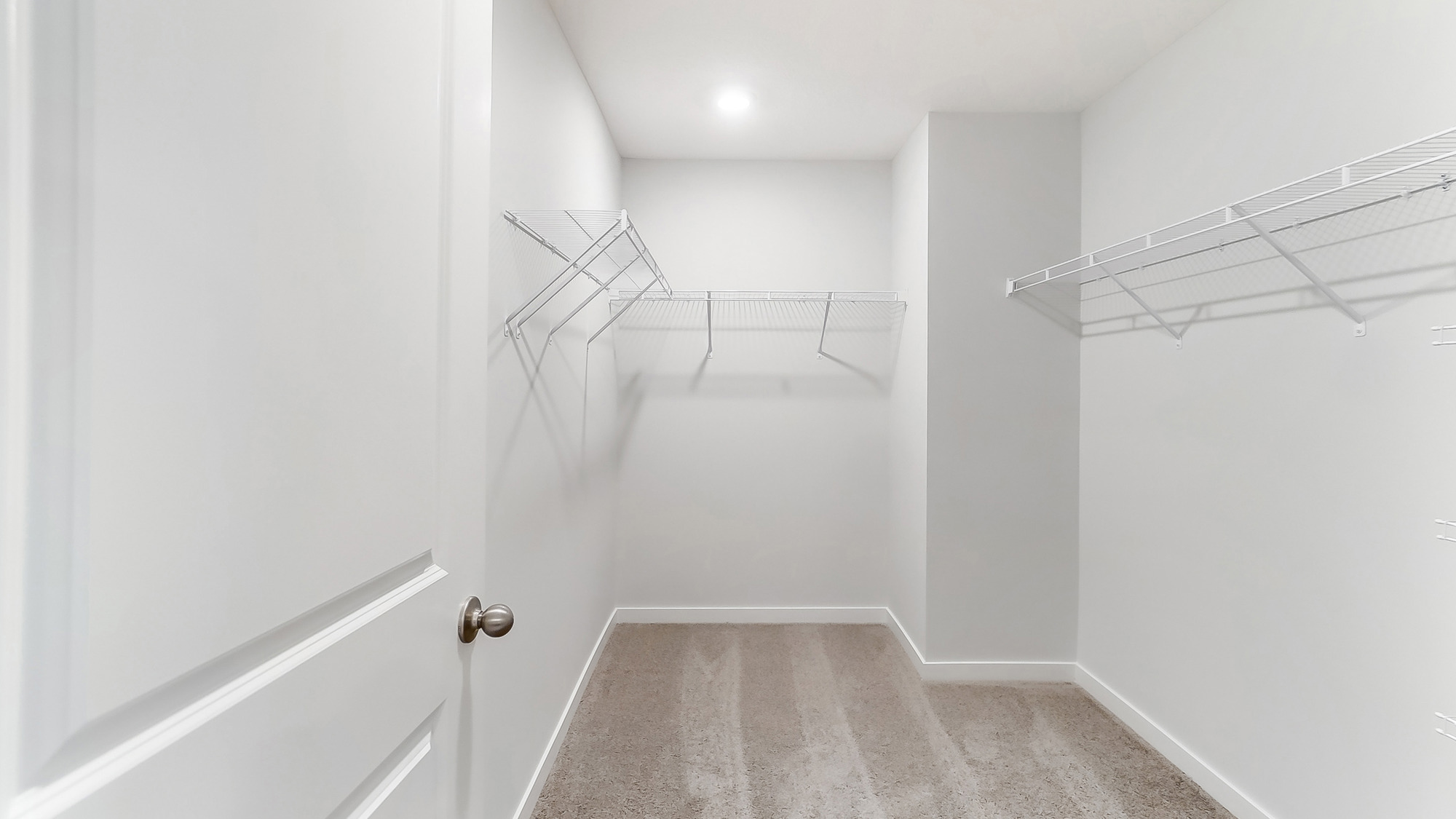 Spacious walk in closet with hanging rod