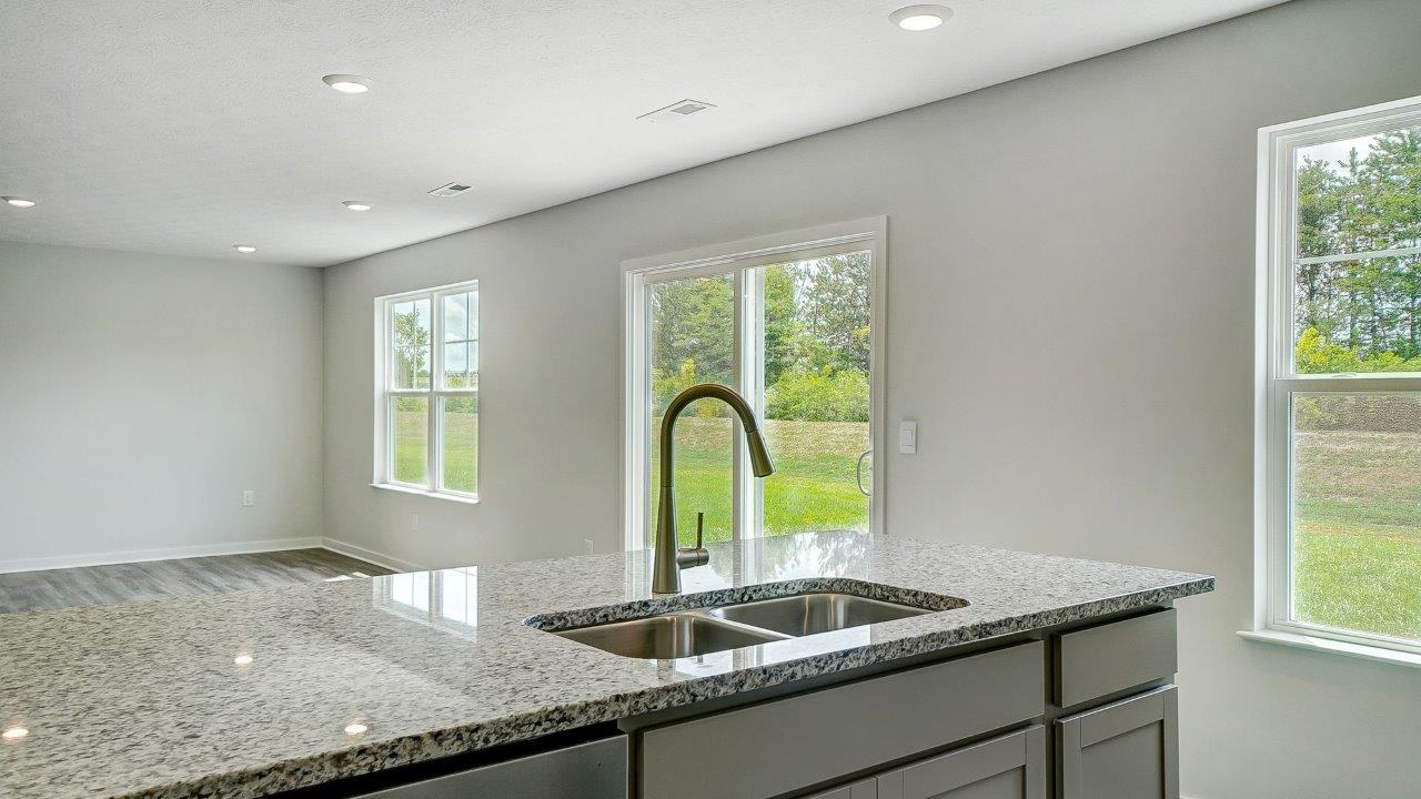 Open kichen connected to dining space with natural light.