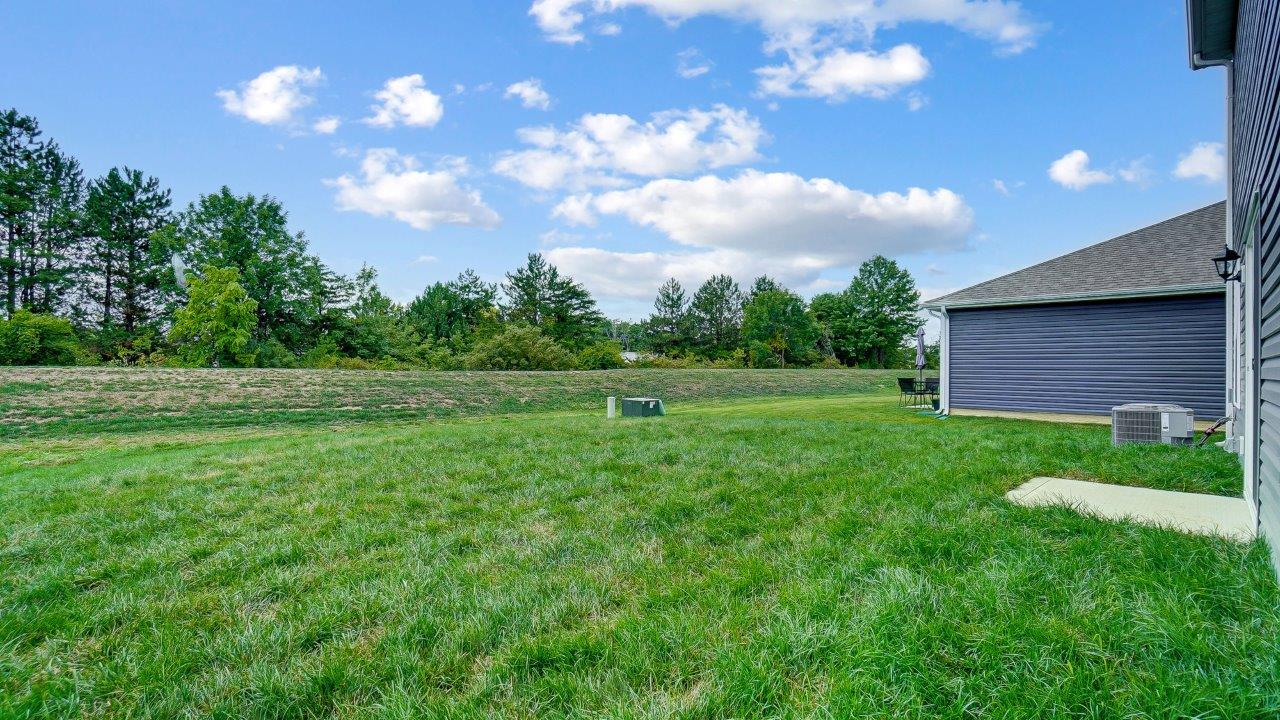 Spacious backyard with a manicured lawn.