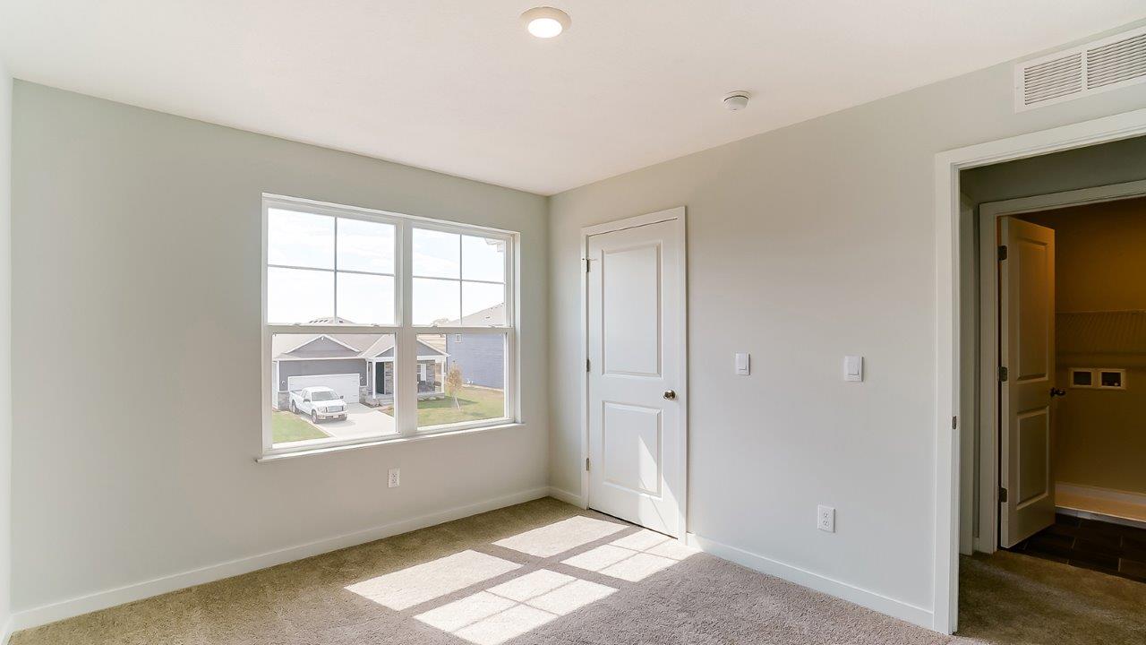 Bedroom with a window and a closet.