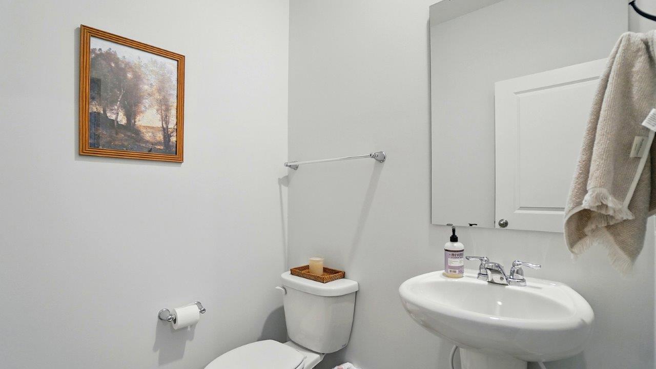 Half bath featuring a standing sink and toilet.