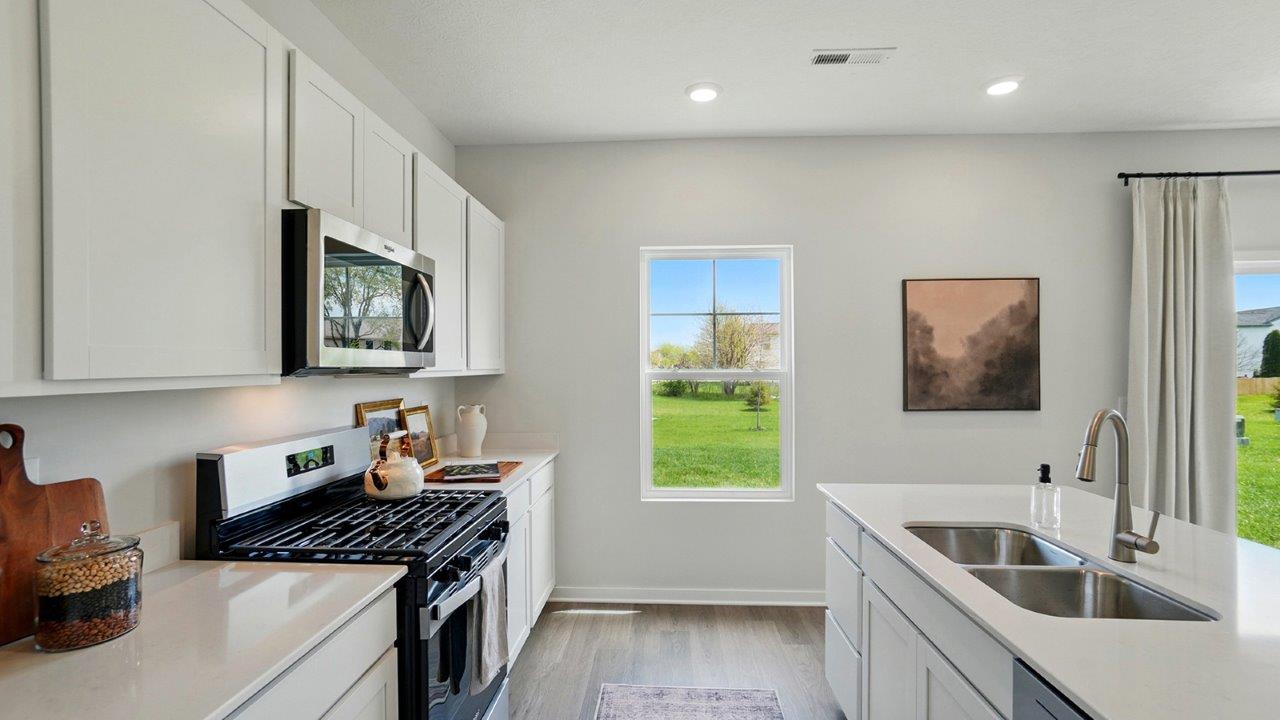 Kitchen with new hard surface countertops and new stainless steel appliances.