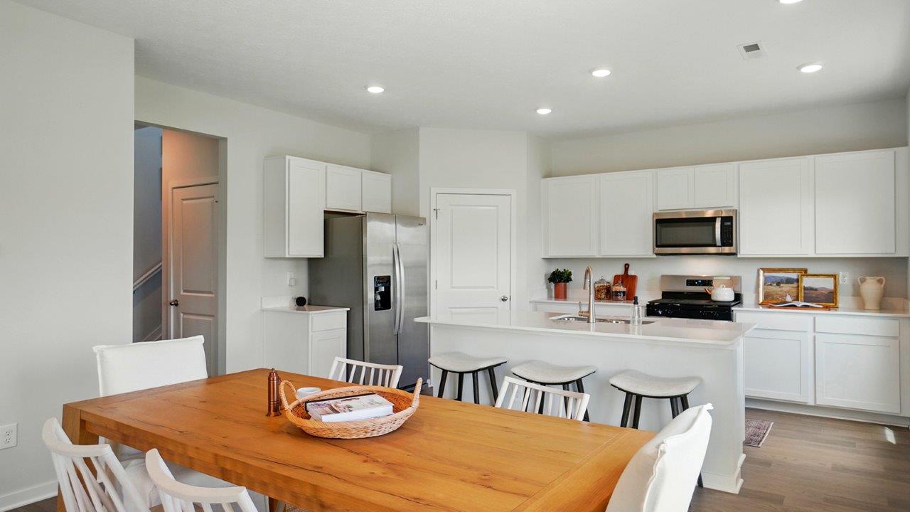 Bright dining area with neutral walls off the kitchen.