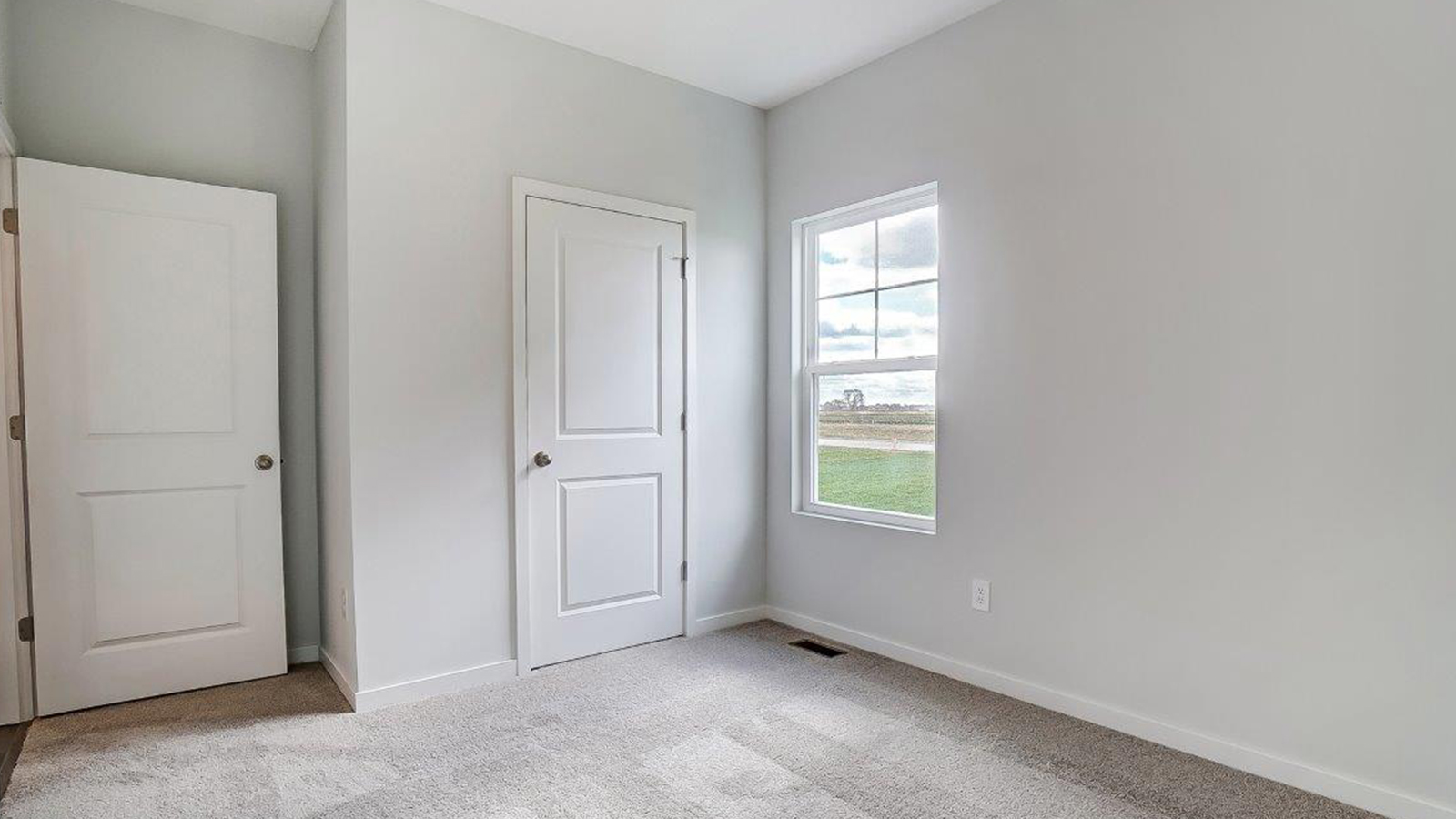 Bedroom with a window and a closet.