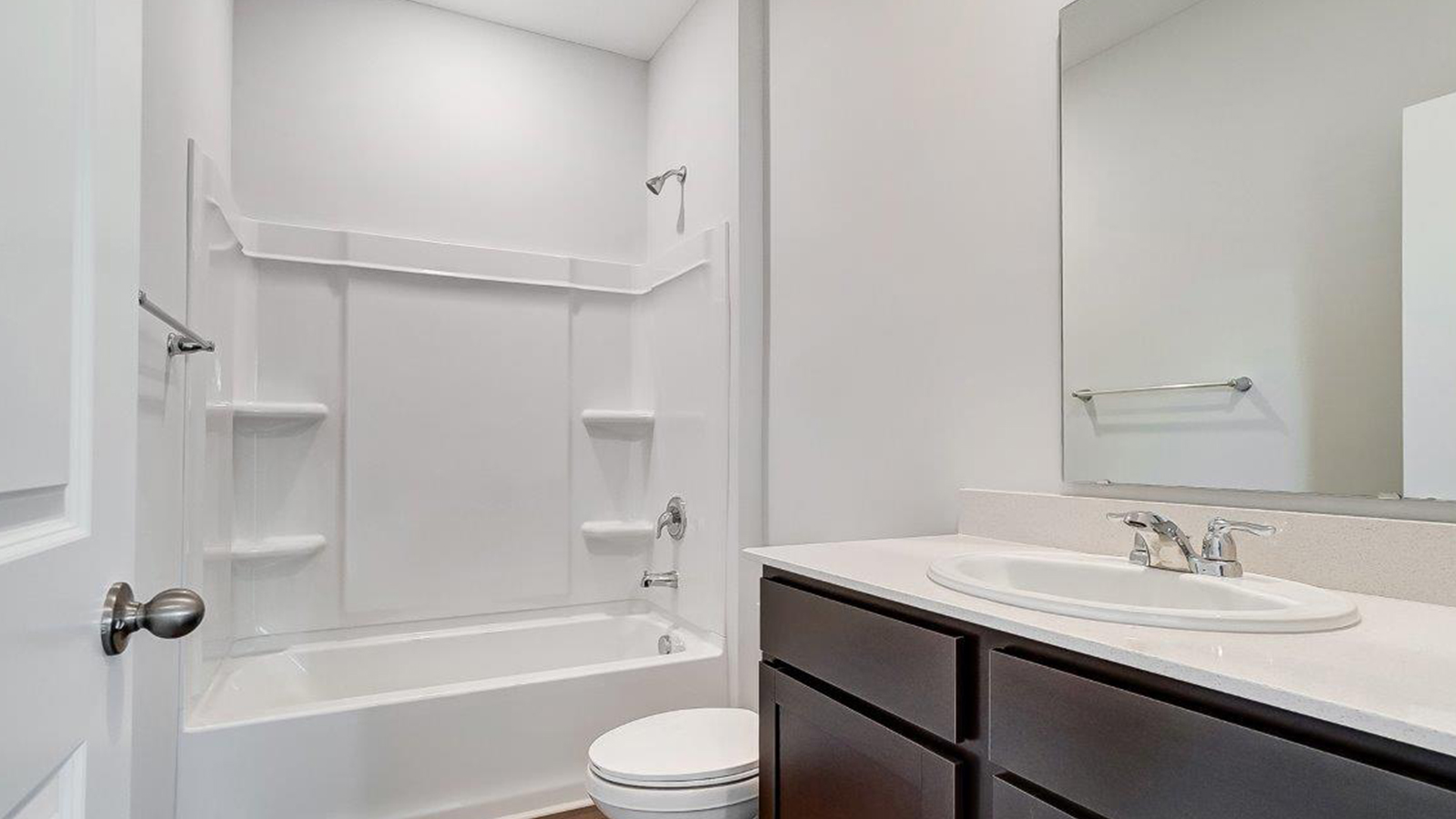Bathroom featuring a sink, toilet, and shower tub.