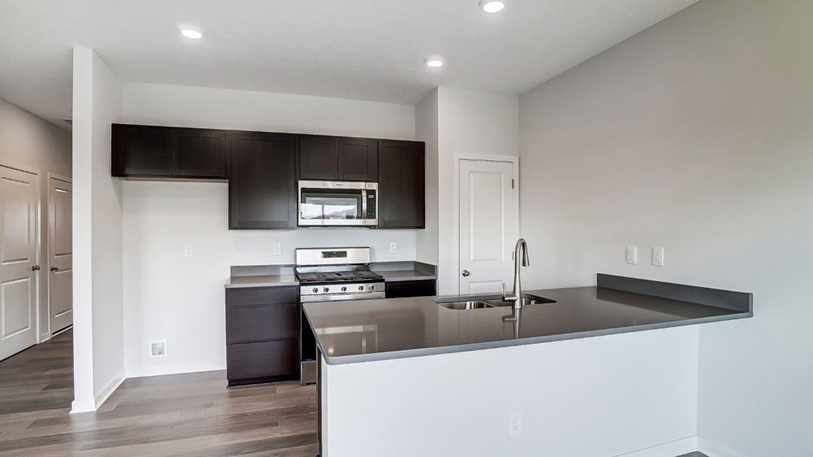 Kitchen featuring brand new stainless steel appliances, cabinets, and a large island.